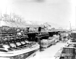 RR cars transfer loads of anthracite (hard) coal to D&H Canal boats in Honesdale, PA. Wayne County Historical Society. HAER PA,64-HOND, 3-1.